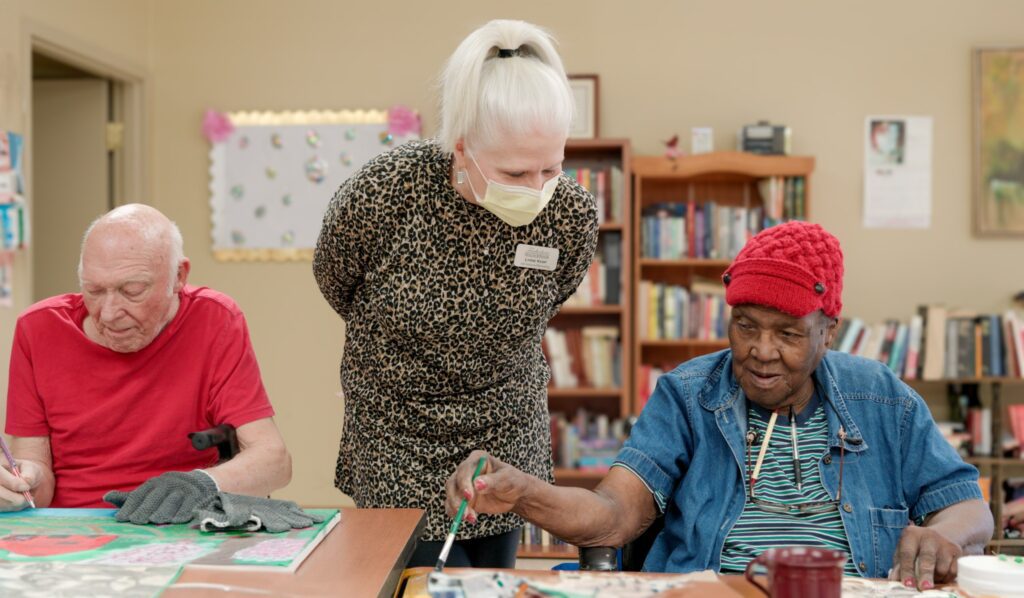 A nurse assists a resident at a skilled nursing facility